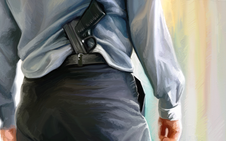 A white man in professional attire, pistol tucked at his back.